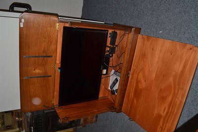 Lot 1140 - A burr walnut motorised TV cabinet containing a Samsung flatscreen TV