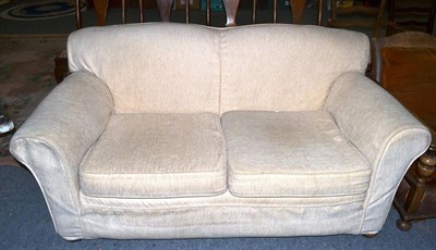 Lot 1149 - A cream two seater sofa