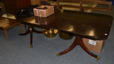 Lot 1156 - A Regency style mahogany twin pillar dining table