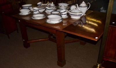 Lot 1306 - A mahogany draw leaf dining table with blind fret carved square section legs