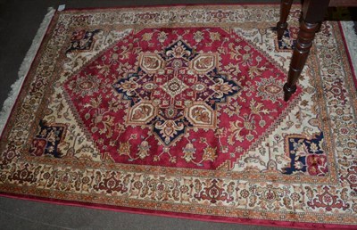 Lot 1322 - An artificial silk rug of Heriz design, the raspberry field with central medallion framed by...