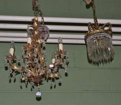 Lot 1328 - A lustre drop ceiling light fitting, a gilt metal leaf form and lustre drop five branch...