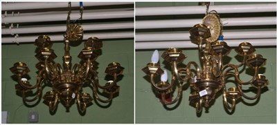 Lot 1329 - A pair of brass twelve light chandeliers