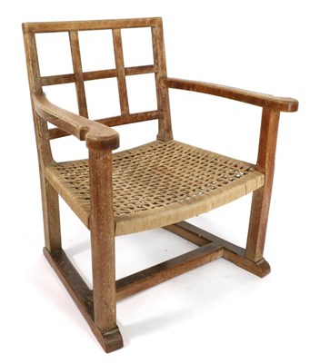 Lot 641 - A Brynmawr Furniture Limed Oak Arm Chair, with slatted back, shaped arms, interwoven seat on square