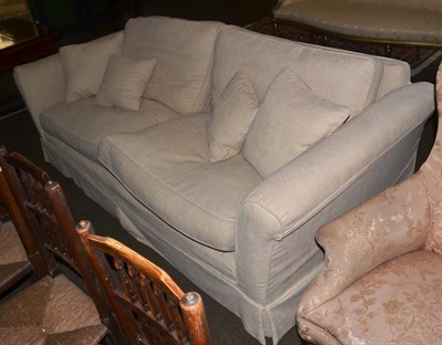 Lot 1352 - A large cream feather filled two seater sofa