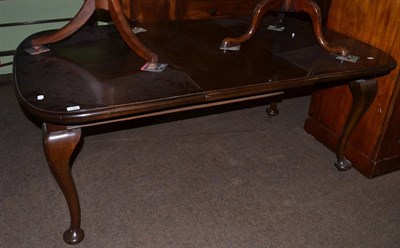 Lot 1368 - Mahogany wind out dining table with one additional leaf, raised on shallow cabriole legs...