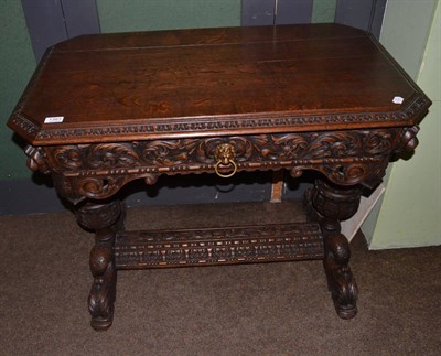 Lot 1383 - A heavily carved oak side table