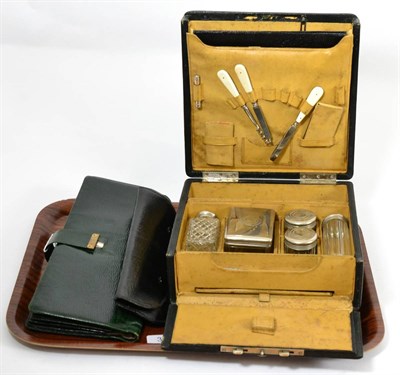 Lot 32 - A green leather glove and accessory case, black leather brush set and a hinged leather mounted...