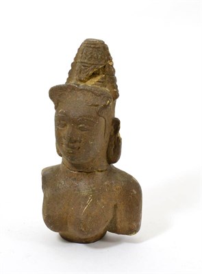 Lot 61 - An Indonesian fragmentary carved stone bust of Shiva, 19th/ 20th century, carved in the round,...