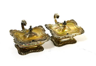 Lot 66 - Two matching late Georgian silver oblong pedestal mustard pots, London 1810 and 1824