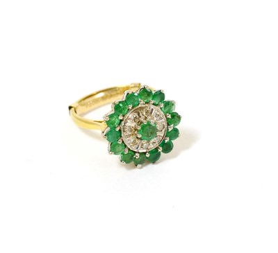 Lot 80 - An 18ct gold emerald and diamond cluster ring