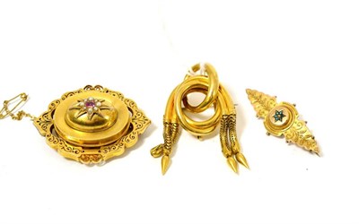 Lot 110 - Three Victorian brooches, one in lozenge form with a pink stone centrally within a border of...