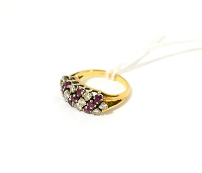 Lot 113 - A ruby and diamond cluster ring, of diagonal rows alternating with round brilliant cut diamonds and