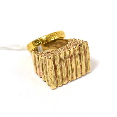 Lot 114 - An 18ct gold patterned band ring, finger size K and a 9ct gold textured chunky ring, finger...