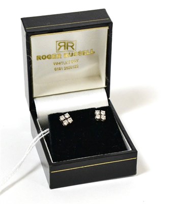 Lot 118 - A pair of diamond cluster earrings, each set with four round brilliant cut diamonds in white claws