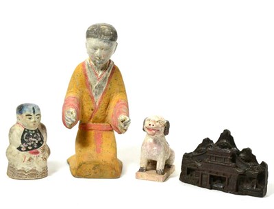 Lot 144 - A Chinese painted terracotta figure of a man, Han Dynasty style, modelled in the round...