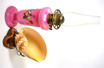 Lot 162 - A Victorian painted pink glass oil lamp and a table lamp modelled from a shell