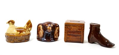 Lot 188 - Four 19th century treacle glaze money boxes modelled as a boot, spaniels head, chicken and chest of