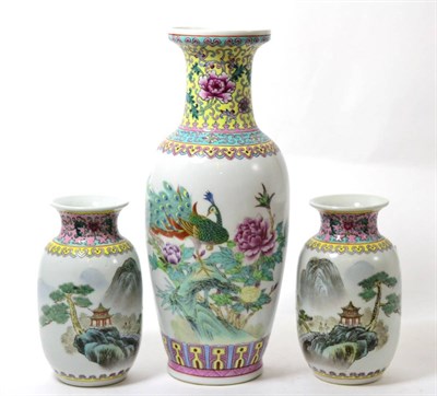 Lot 190 - A Chinese porcelain vase decorated with a peacock together with a smaller pair decorated with...