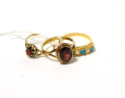 Lot 244 - Two 9ct gold garnet dress rings and a 9ct gold turquoise and pearl set ring