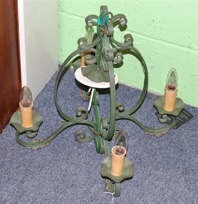 Lot 287 - An early 20th century green painted wrought iron four branch candelabra