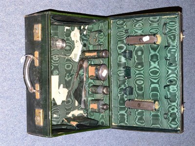 Lot 288 - A black leather dressing case with silk lining containing some silver mounted fittings, two...