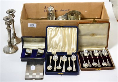 Lot 322 - Silverware including cased sets of spoons and napkin rings, a cigarette case, a watch, candlesticks