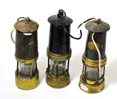 Lot 341 - Thomas & Williams Aberdare Makers miners lamp and two others with brass mounts (3)