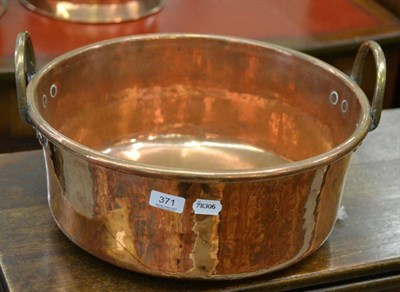 Lot 371 - A large copper two handled preserve pan