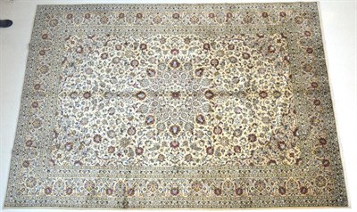 Lot 696 - Kashan Carpet Central Iran, circa 1960 The cream field with an allover design of palmettes and...