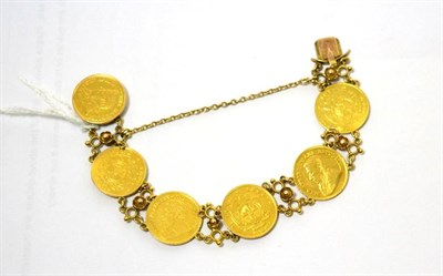 Lot 409 - A bracelet made up with six 1/2 Pond cons with 15ct gold clasp