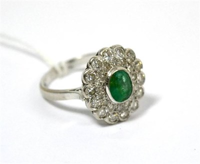 Lot 419 - An emerald and diamond cluster ring, stamped '18CT', total estimated diamond weight 1.20 carat...