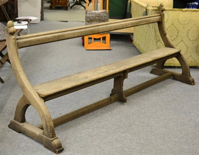 Lot 1018 - An oak pew with open back