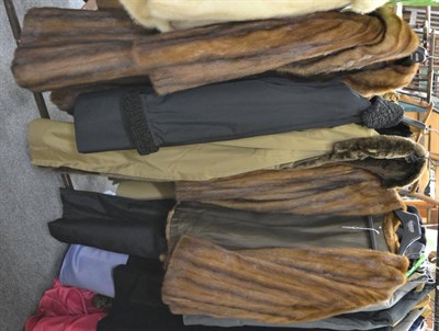 Lot 1022 - A wild mink coat and jacket, brown raincoat lined in nutria, black raincoat lined in astrakhan...