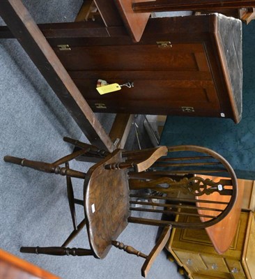 Lot 1039 - A panelled oak corner cupboard and an oak reproduction wheel back Windsor style chair