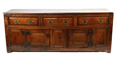 Lot 716 - An Early 18th Century Oak Enclosed Low Dresser, the moulded top above three long drawers, the...