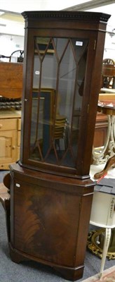 Lot 1061 - A reproduction standing corner cabinet