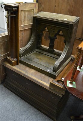 Lot 1070 - A large square stepped oak base, wood panelling with attached columns and an oak Gothic style...