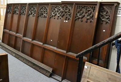 Lot 1072 - A quantity of ecclesiastical oak panels with Gothic style fret carving and a long oak plinth...