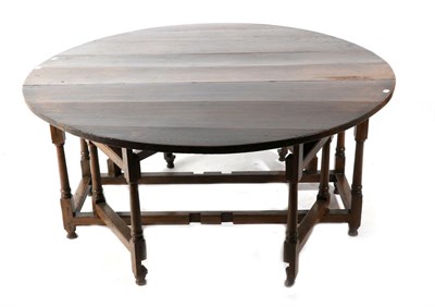 Lot 724 - An Early 18th Century Six-Seater Gateleg Table, with two drop leaves to form an oval above two...