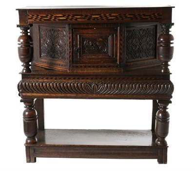 Lot 728 - A 17th Century and Later Joined Oak Standing Livery Cupboard, the top with a holly and bog oak...