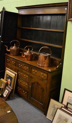 Lot 1196 - An 18th century style panelled oak dresser and rack