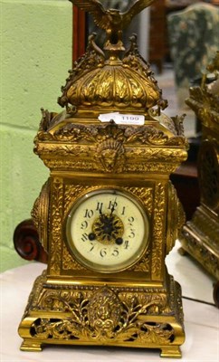 Lot 1199 - A decorative embossed and pierced brass mantle clock