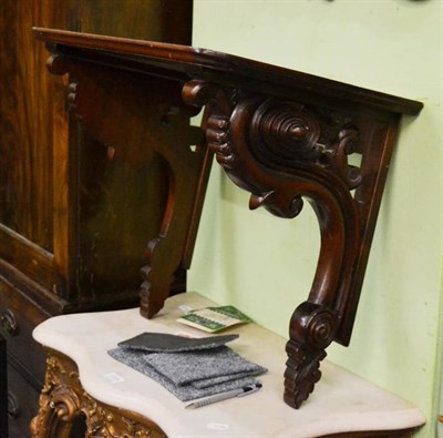 Lot 1205 - A mahogany wall bracket with carved scrolls