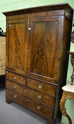 Lot 1207 - A George III mahogany linen press, with dentil cornice, converted to a wardrobe