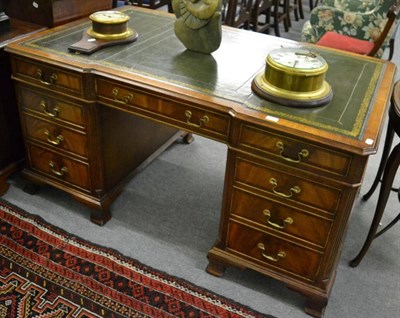 Lot 1250 - A modern mahogany partners desk with green leather and gilt tooled top