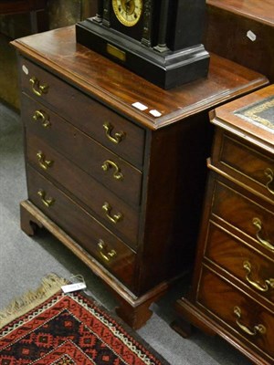 Lot 1252 - A mahogany Georgian small four height chest of drawers