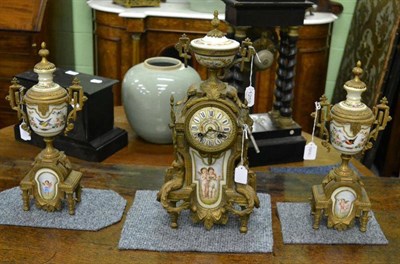 Lot 1259 - A composite Continental gilt metal mounted clock garniture