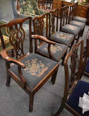 Lot 1266 - A set of six Georgian mahogany dining chairs with carved splats and floral covered seats, including