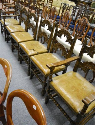 Lot 1269 - A set of six reproduction carved oak dining chairs with turned front rail and leather seats,...